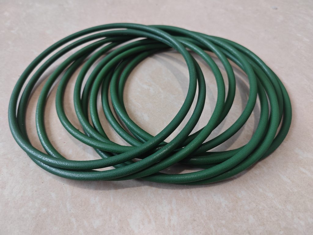 A set of Movendis Molded PU Round Belts lie arranged on a light-colored surface.