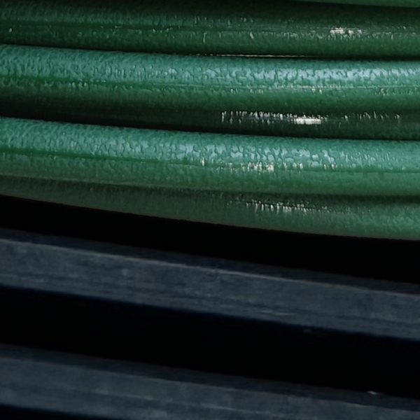 Close-up image of the Movendis roller-to-roller portfolio, showcasing a green Molded PU Round Belt on top and a black Poly-V EPJ belt on the bottom.