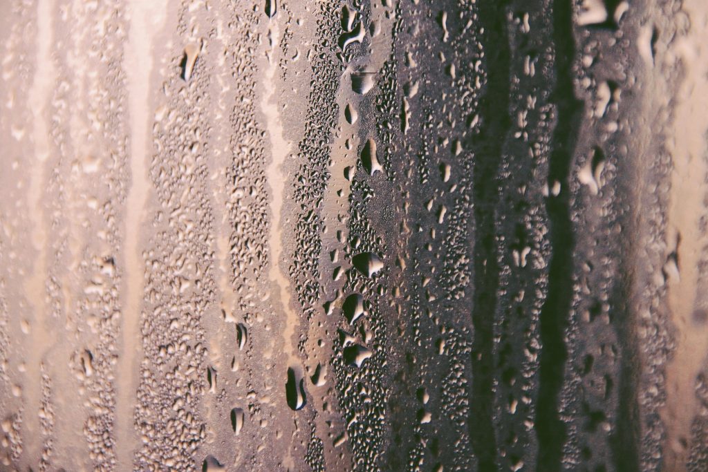 The image showcases humidity in a glass wall.